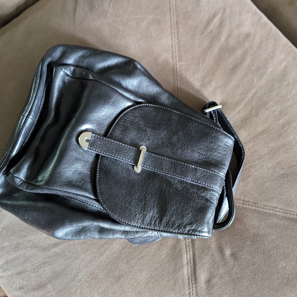 Sleek Black Backpack with Glossy Finish and Structured Design